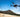 Aeroo Pro fishing drone with bait release flying over Australian beach - shop at Vision Plus Hobart and Brisbane