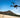 Aeroo Pro fishing drone with bait release flying over Australian beach - shop at Vision Plus Hobart and Brisbane